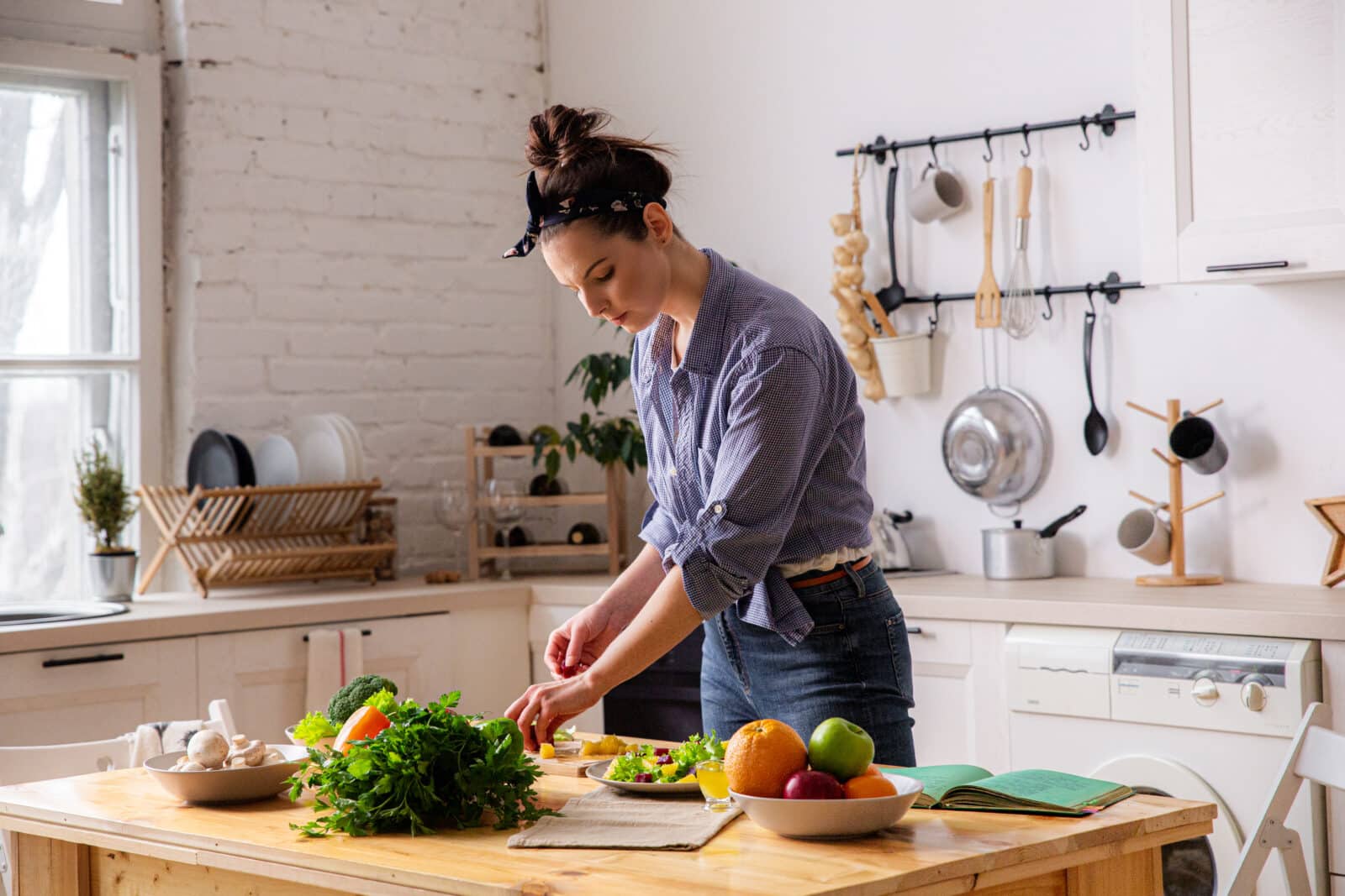 Young and beautiful housewife woman cooking in a kitchen