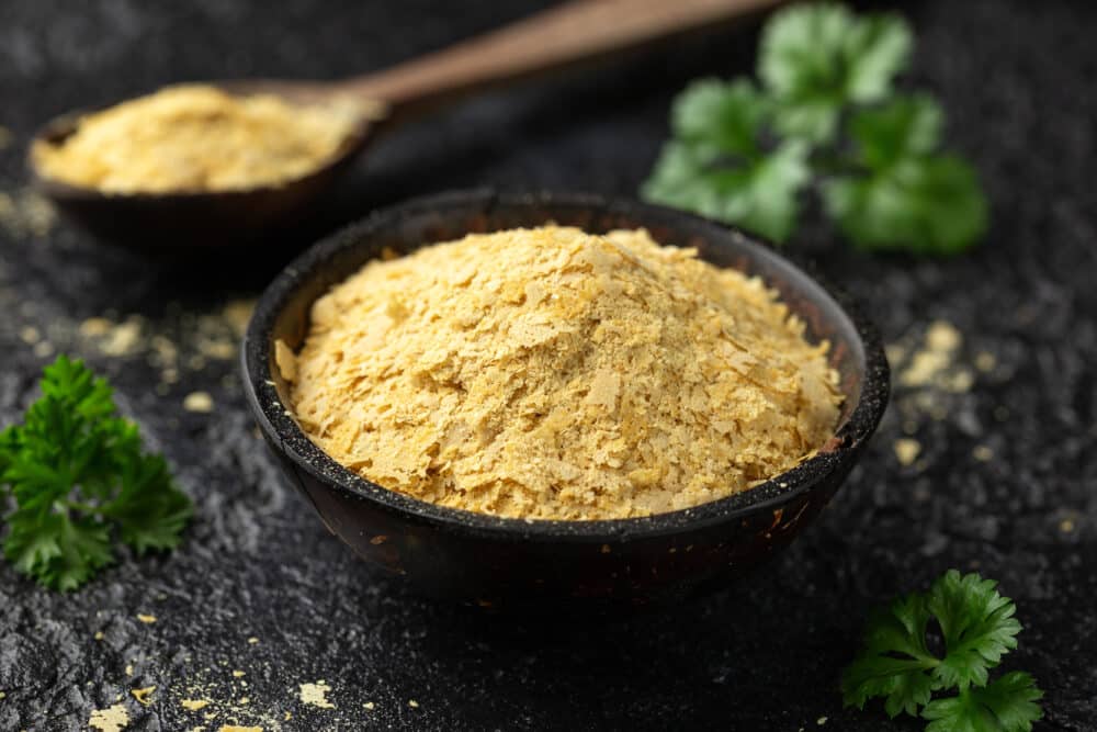 Dried nutritional yeast flakes, vegan vegetarian seasoning healthy food supplement.